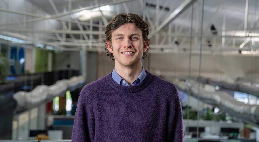 man standing in open plan office