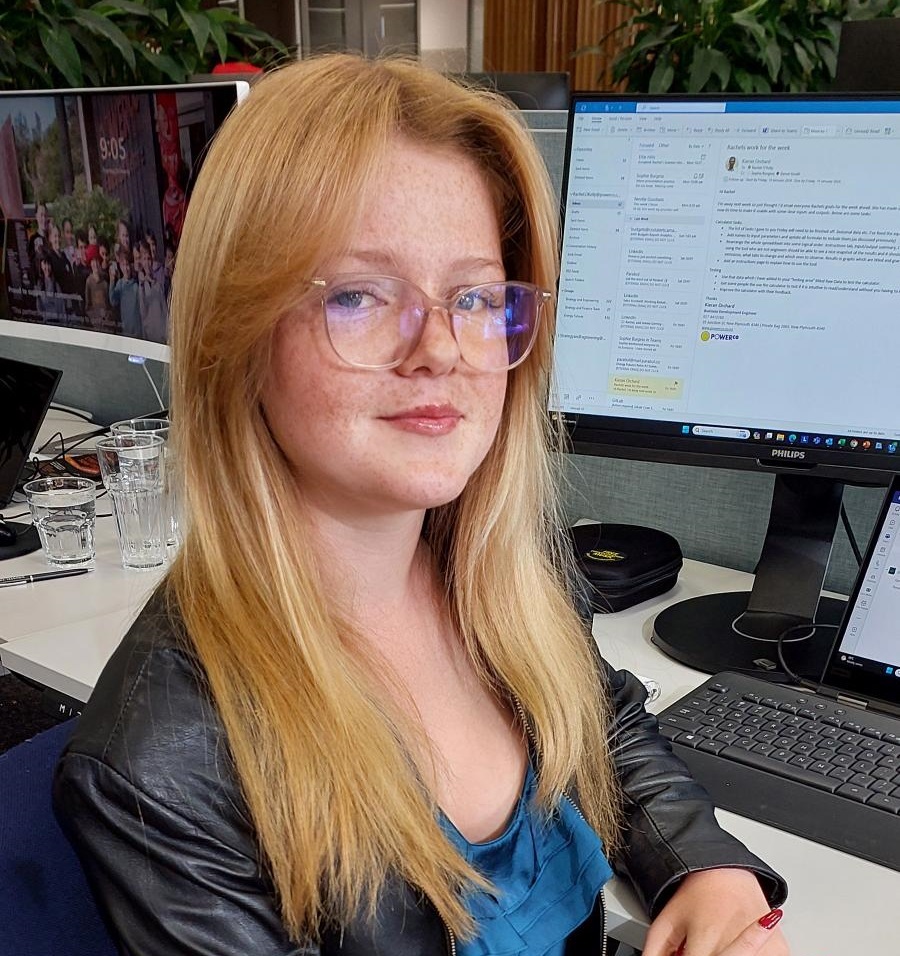 Young woman with long red hair and glasses