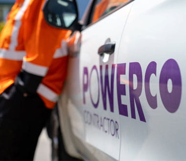 person in PPE gear standing against a ute