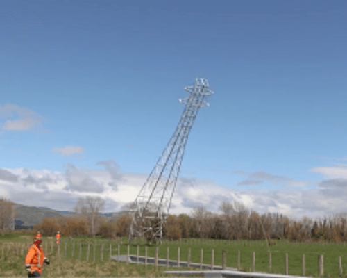 Lattice tower being felled