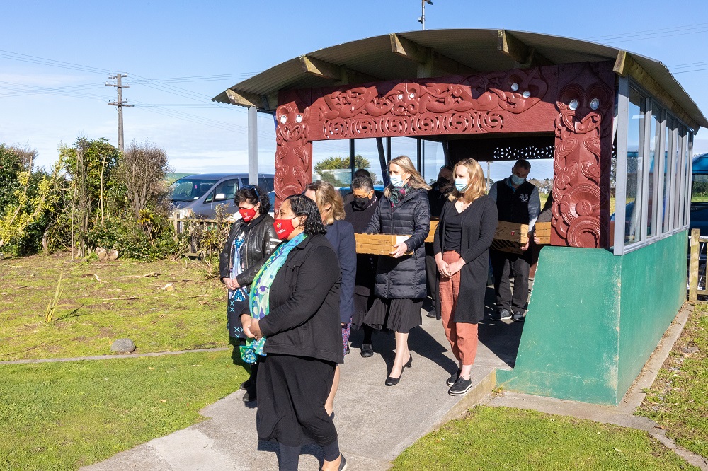 Powerco team members are welcomed into Te Kura o Ngaruahinerangi Tumuaki to donate the laptops.