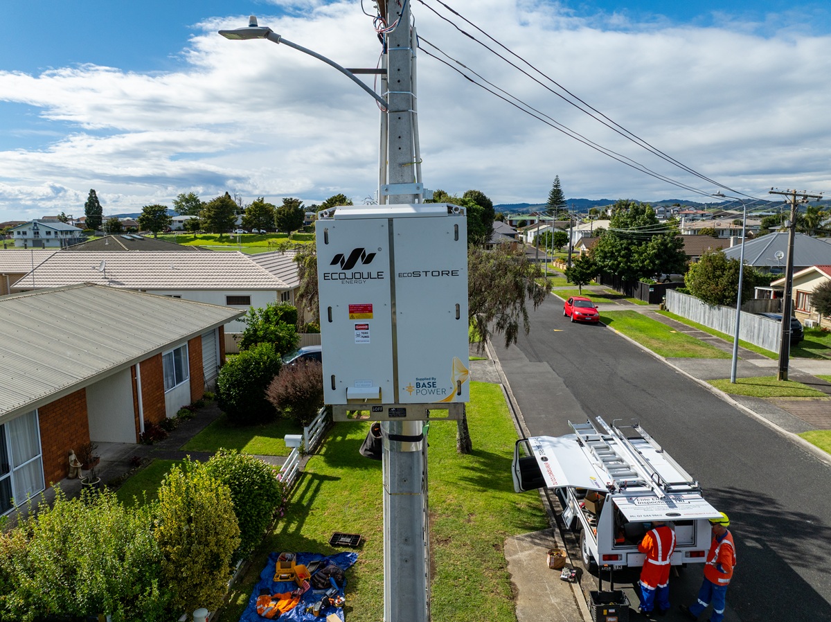 Aerial footage of an electrical box connected to a concrete pole pole.