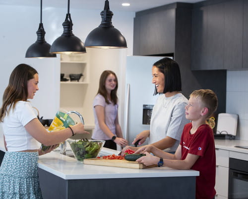 Family in a home kitchen. 