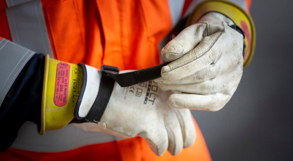 person putting on electrical safety gloves