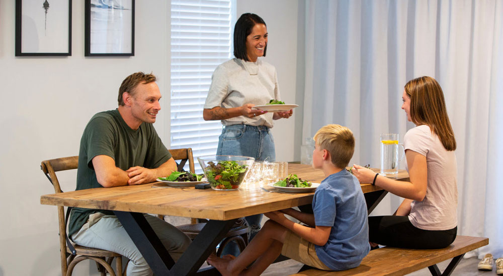 family sitting up dining table having dinner