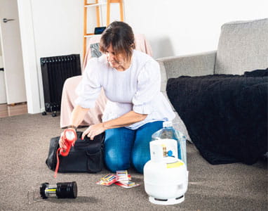 women packing power outage items into bag