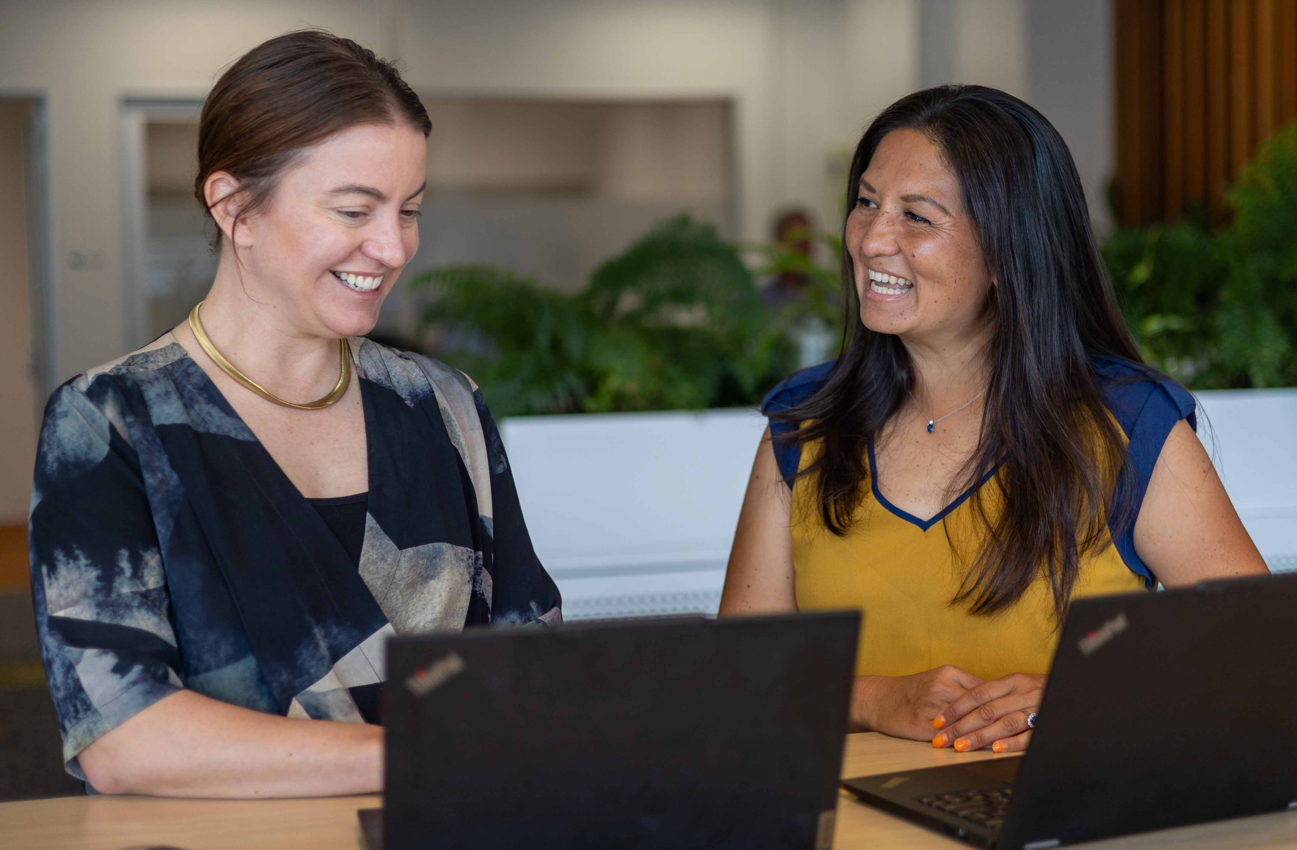two women talking in office