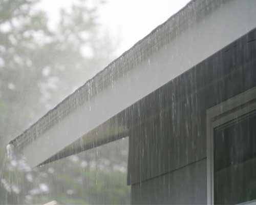 Rain falling on house roof