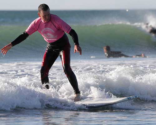 Man surfing at Fitzroy beach New Plymouth
