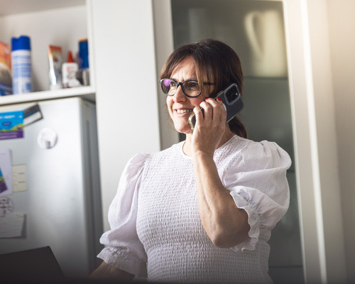 woman on phone in kitchen