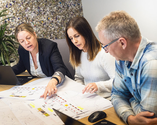 staff members looking at documents in meeting room