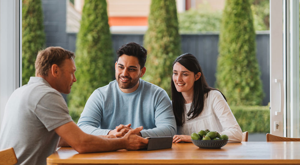 People sitting at dining table with gas fitter