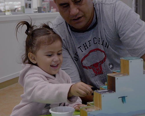Young girl and adult playing.