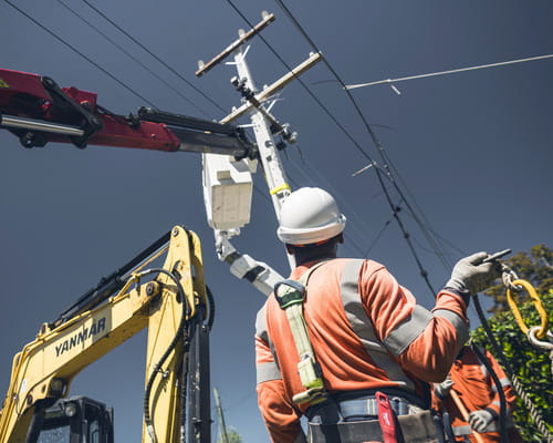 Linesmen replacing a power pole