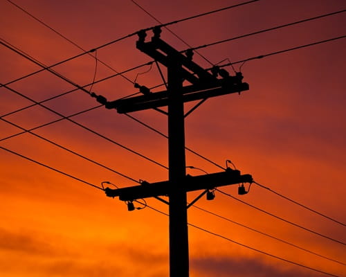 Top of power pole with sunset 