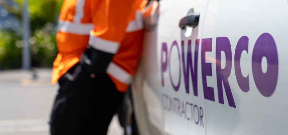 contractor leaning against a Powerco ute